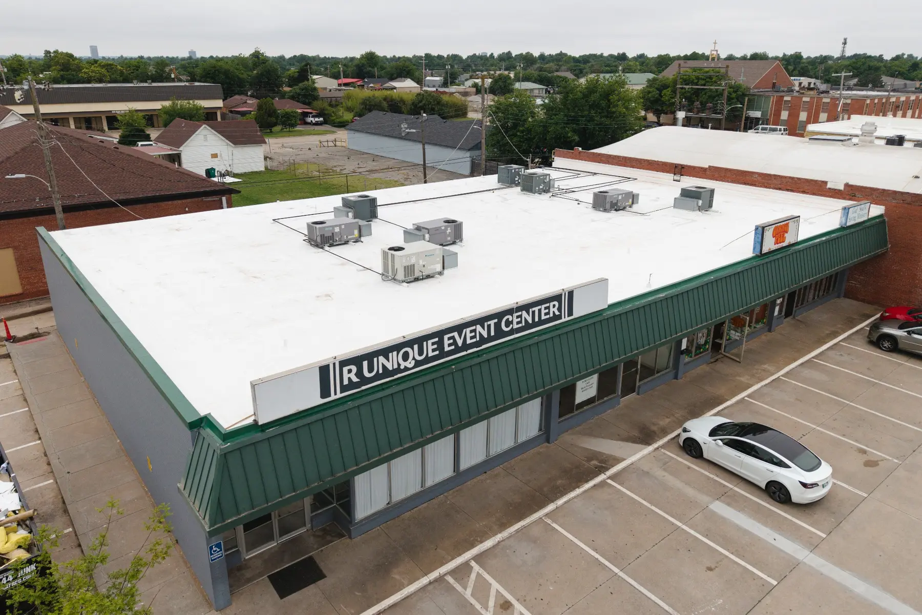 Drone view of completed white commercial roof at Britton District